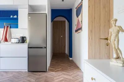 a kitchen with a refrigerator and a door to a hallway at Modern Luxury 2BR|Park View & Balcony in Nicosia