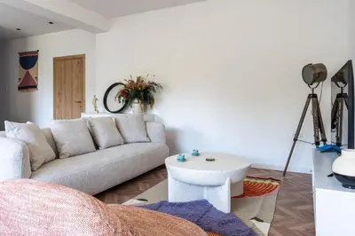a living room with a couch and a table at Modern Luxury 2BR|Park View & Balcony in Nicosia