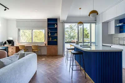 a kitchen and living room with a blue bar at Modern Luxury 2BR|Park View & Balcony in Nicosia