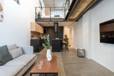 a living room with a couch and a table at Cozy Loft with Balcony in Central Limassol in Limassol