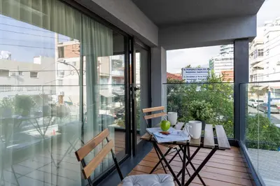 a balcony with a table and chairs on a balcony at Cozy Loft with Balcony in Central Limassol in Limassol