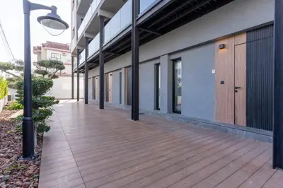 an empty hallway of a building with a wooden deck at Cozy Loft with Balcony in Central Limassol in Limassol