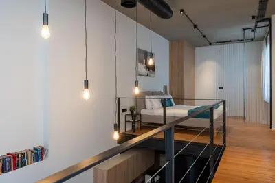 a bedroom with a bed and a desk in a room at Cozy Loft with Balcony in Central Limassol in Limassol