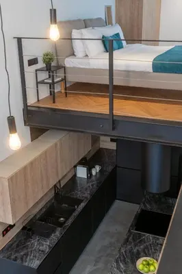 a room with a bed and a sink in a room at Cozy Loft with Balcony in Central Limassol in Limassol