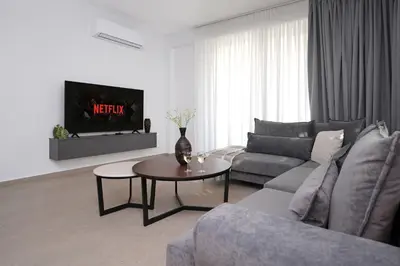 a living room with a couch and a table at Villa Esmeralda - Luxury Villa in Pernera in Paralimni