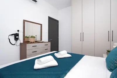 a bedroom with a bed with two towels on it at Villa Esmeralda - Luxury Villa in Pernera in Paralimni