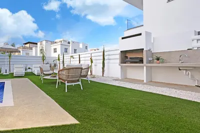 a patio with a table and chairs on a lawn at Villa Esmeralda - Luxury Villa in Pernera in Paralimni