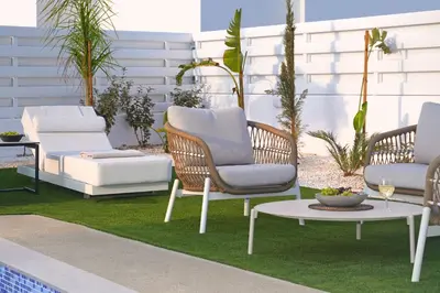 a patio with three chairs and a table on grass at Villa Esmeralda - Luxury Villa in Pernera in Paralimni