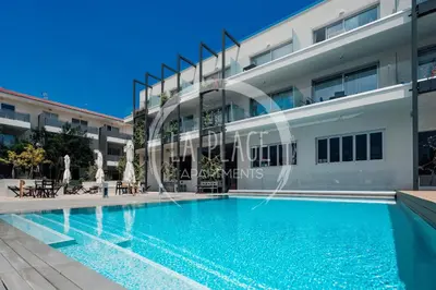 a swimming pool in front of a building at Sunny 2Br Family Apartment - Mythical Sands Resort in Protaras