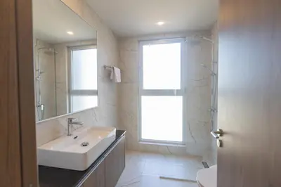 a bathroom with a sink and a shower and a window at Mythical Blue Villas in Protaras
