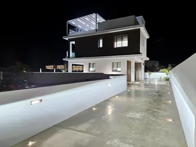 a white house with a glass roof at night at Mediterranean Sunrise Villa Protaras in Paralimni