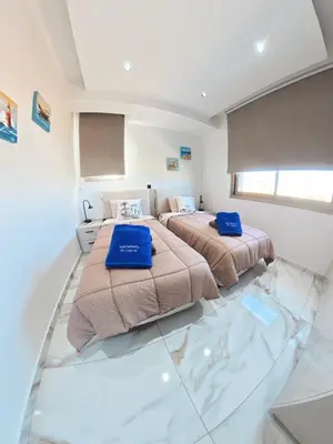two beds in a room with a glass floor at Mediterranean Sunrise Villa Protaras in Paralimni
