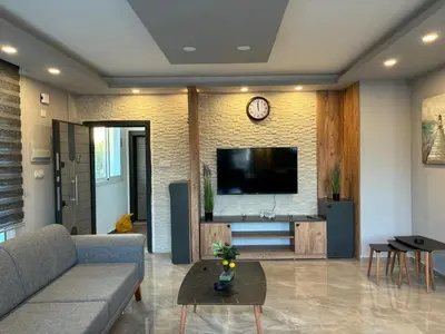 a living room with a couch and a flat screen tv at Veray Homes in Nicosia