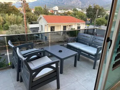a patio with a table and chairs on a balcony at Veray Homes in Nicosia
