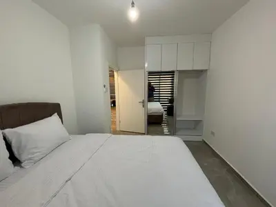 a bedroom with a large white bed and a room at Veray Homes in Nicosia