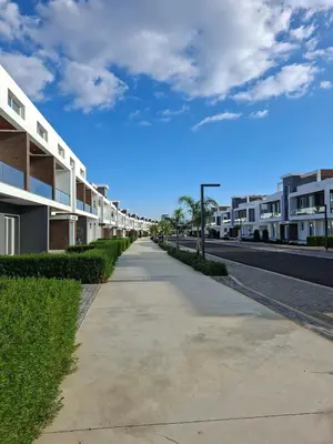an empty sidewalk next to a street with buildings at Chic Blue Apartment with Terrace in Paralimni