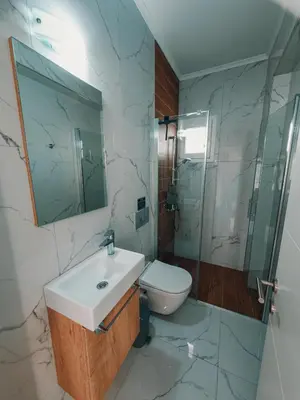 a bathroom with a sink and a toilet and a shower at Chic Blue Apartment with Terrace in Paralimni