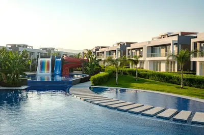 a pool with a water slide in a resort at Chic Blue Apartment with Terrace in Paralimni