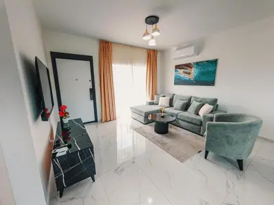 a living room with a couch and a table at Chic Sunset Apartment with Terrace in Protaras
