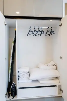 a closet filled with white towels and hangers at Panorama Comfort Nest in Paralimni