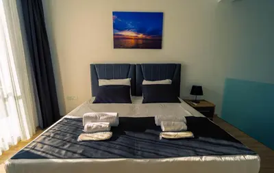 a large bed with two pillows on top of it at Stylish Loft - 50m from Beach in Paralimni