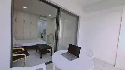 a laptop computer sitting on a white table in a room at STAY Terra Cota Studio in Limassol