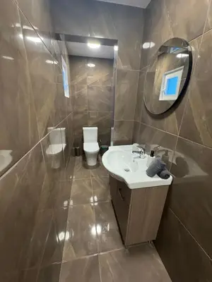 a bathroom with a sink and a toilet and a mirror at Limassol center Soul in Limassol