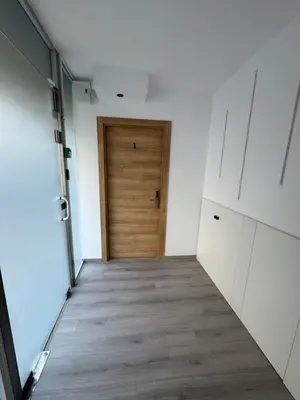 a hallway with a wooden door in a room at Limassol center Soul in Limassol