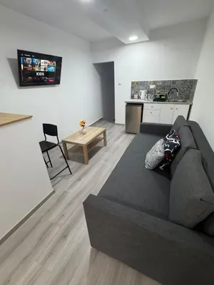 a living room with a couch and a kitchen at Limassol center Soul in Limassol
