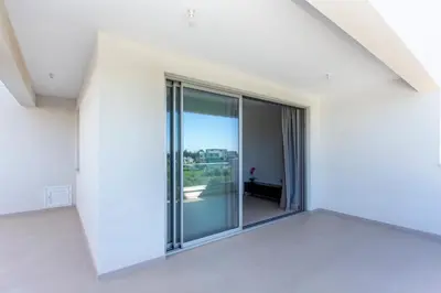 an empty white room with sliding glass doors at BlueStar Limassol Suites in Limassol
