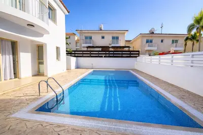 a swimming pool in the backyard of a house at Villa Dolce Vita II in Protaras