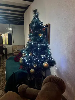 a christmas tree with blue lights in a living room at Mountain Retreat in Kakopetria, Cyprus - Perfect for Families in Kakopetria
