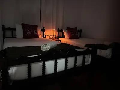 a dark room with two beds in a bedroom at Mountain Retreat in Kakopetria, Cyprus - Perfect for Families in Kakopetria