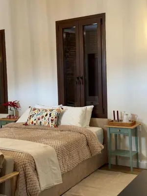 a bedroom with a bed and two night tables at Aprosmeno Jacuzzi House 7 in Agros