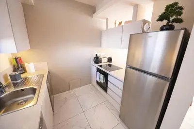 a kitchen with a stainless steel refrigerator and a sink at Mythical Sands 2 - G in Aglantzia
