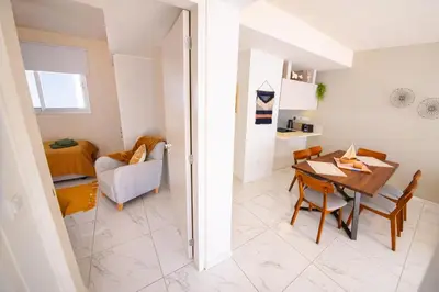 a kitchen and dining room with a table and chairs at Mythical Sands 2 - G in Aglantzia