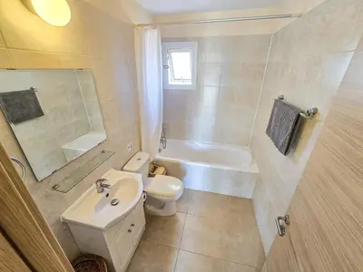 a bathroom with a sink and a toilet and a bath tub at Mythical Sands 2 - B in Paralimni