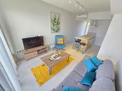 a living room with a couch and a table at Mythical Sands 2 - B in Paralimni