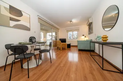 a living room with a table and chairs at 2 bedroom flat in center in Nicosia
