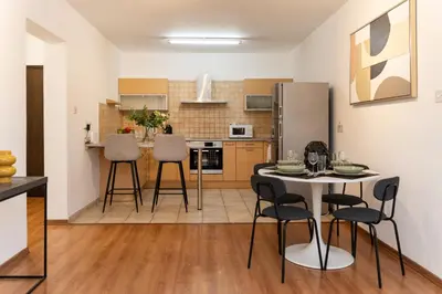 a kitchen with a table and chairs in a room at 2 bedroom flat in center in Nicosia