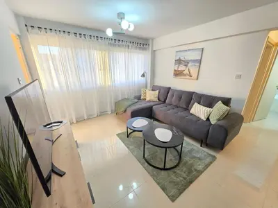 a living room with a couch and a table at Thea Court 1 - A in Paralimni