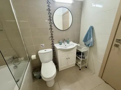 a bathroom with a toilet and a sink and a mirror at Thea Court 1 - A in Paralimni