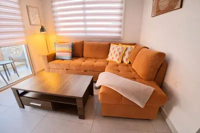 a living room with a couch and a coffee table at Mythical Sands 2 - F in Paralimni