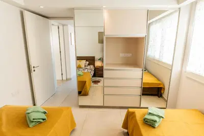 a bedroom with two beds and a mirror at Mythical Sands 2 - F in Paralimni