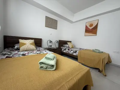 a bedroom with two beds with towels on them at Mythical Sands 2 - F in Paralimni