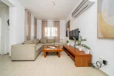 a living room with a couch and a coffee table at 2 bedroom flat in Strovolos