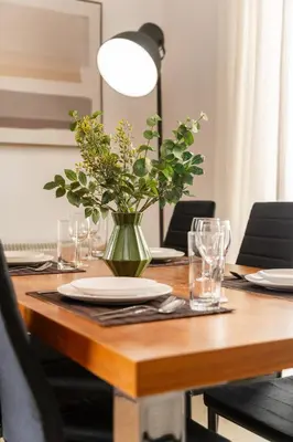 a wooden table with a vase of flowers on it at 2 bedroom flat in Strovolos
