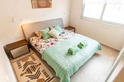 a small bedroom with a bed and a window at Mythical Sands 2 - E in Paralimni