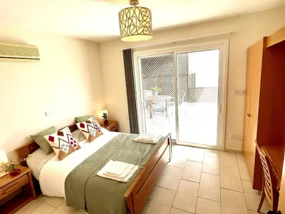 a bedroom with a bed and a sliding glass door at Stunning villa with breathtaking sea view in Pissouri