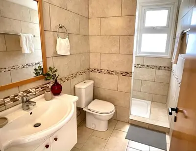 a bathroom with a white toilet and a sink at Stunning villa with breathtaking sea view in Pissouri